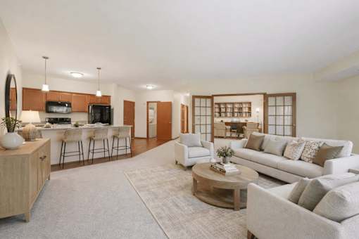 Open concept living room and kitchen with island seating at The Estates at Arbor Oaks Apartments, Minnesota, 55304