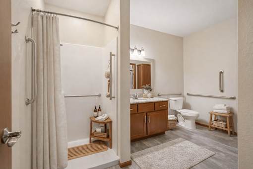 Accessible bathroom with grab bars and walk in shower at The Estates at Arbor Oaks Apartments, Andover, Minnesota
