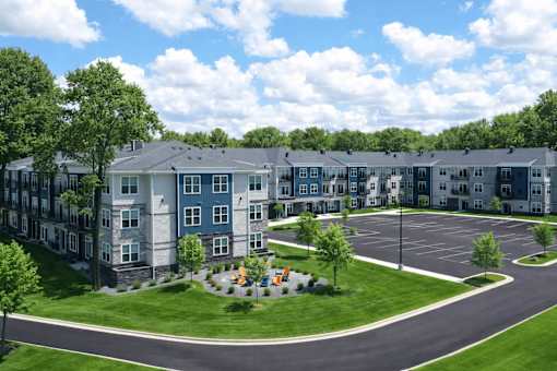 A large apartment complex with a roundabout in the front.