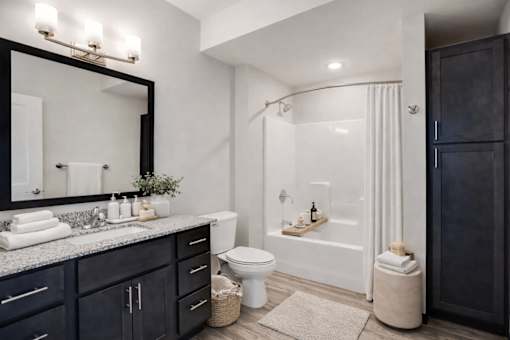 A bathroom with a black cabinet and a white toilet.
