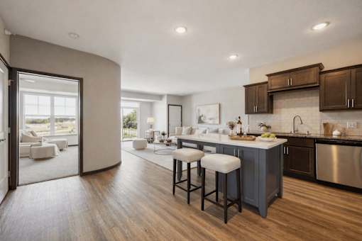 A modern kitchen with a bar stool in front of it.