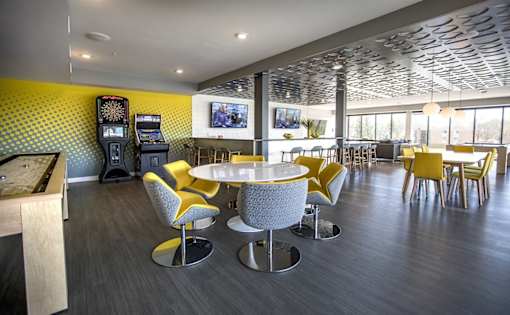 Community lounge with game area and seating at Hello Apartments, Minneapolis