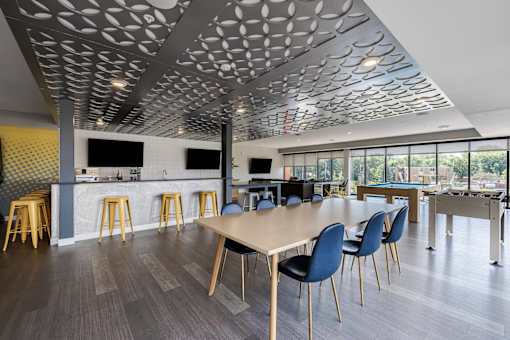 Modern coworking space with dining and kitchen area at Hello Apartments, Minneapolis, Minnesota