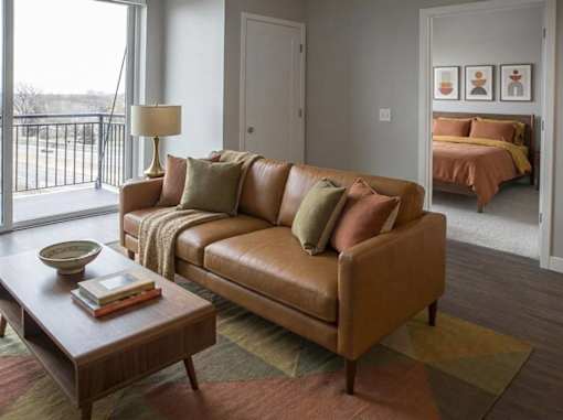 Modern living room with leather sofa and balcony view at Hello Apartments, Minneapolis