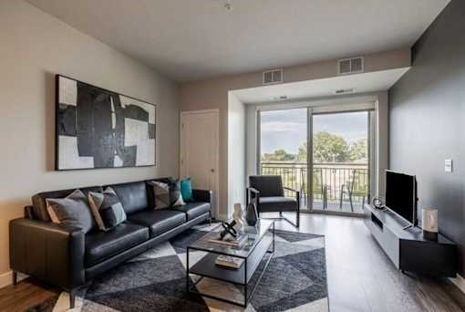 Modern living room with balcony and greenspace views at Hello Apartments, Minnesota