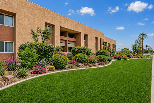A building with a green lawn in front of it.