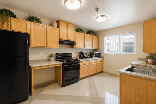 A kitchen with wooden cabinets and black appliances.