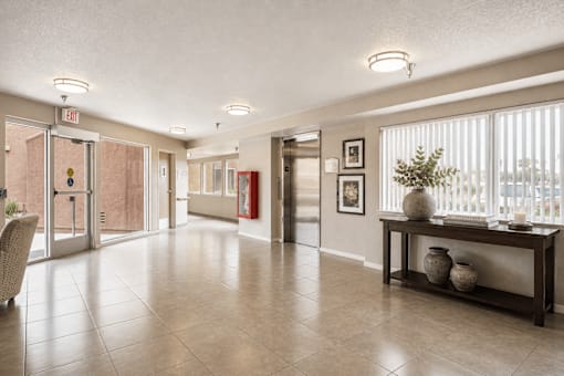 A spacious hallway with a bench and a chair.