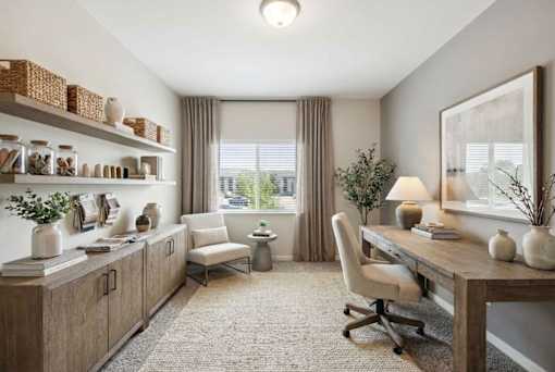 A well-lit room with a desk, chair, and shelves with decorative items at Aster Meadow, Vadnais Heights, MN, 55127