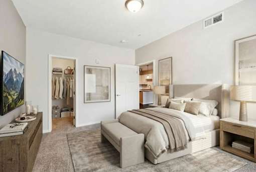 A bedroom with a large bed, a nightstand, and a painting on the wall at Aster Meadow, Vadnais Heights, MN, 55127