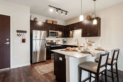 A kitchen with a table and chairs set for two at Aster Meadow, Vadnais Heights, MN, 55127