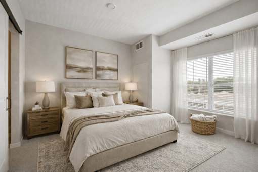 Spacious bedroom with upholstered bed and neutral decor at The Hendrickson Apartments, Minnesota, 55113