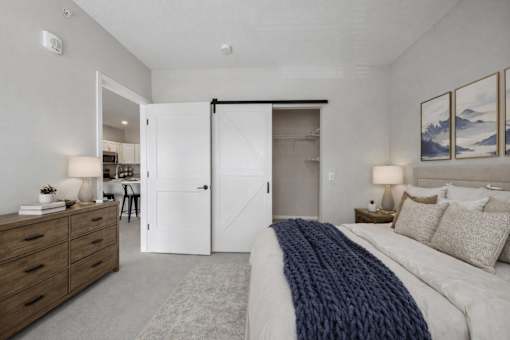 Spacious bedroom with barn door closet at The Hendrickson Apartments, Falcon Heights, MN 55113