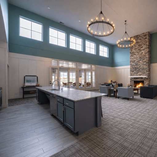 Clubhouse with kitchen island and fireplace lounge at The Hendrickson Apartments, Falcon Heights, 55113