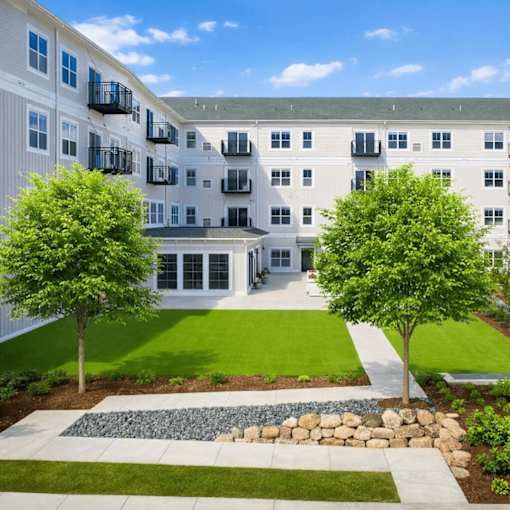 Courtyard with green lawn and landscaping at The Hendrickson Apartments, Falcon Heights