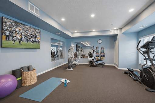 Fitness center with cardio and strength equipment at The Hendrickson Apartments, Minnesota, 55113