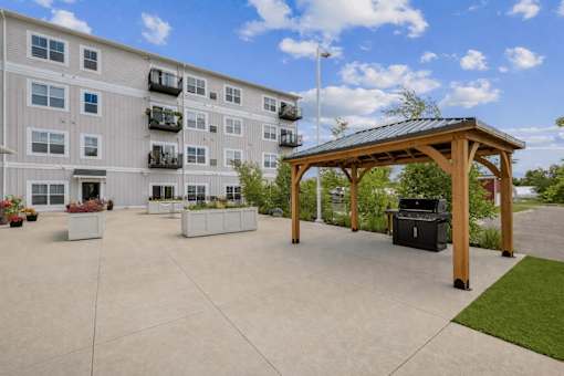 Outdoor patio with grilling station and pergola at The Hendrickson Apartments, Falcon Heights, MN 55113