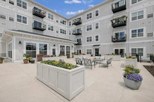 Interior courtyard with seating area and planter boxes at The Hendrickson Apartments, Falcon Heights, MN