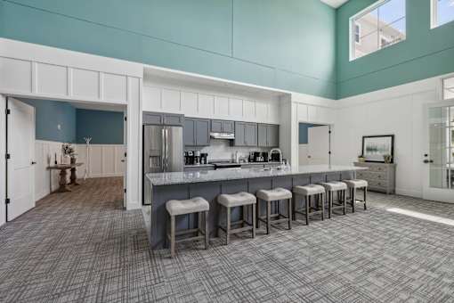 Community kitchen with island seating and gray cabinetry at The Hendrickson Apartments, Falcon Heights, 55113