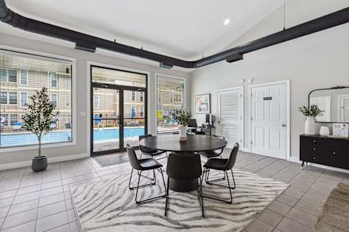 A dining room with a table set for four.