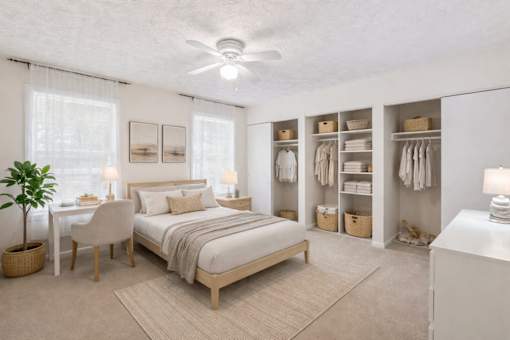 A bedroom with a bed, chair, and a plant at Emerald Pointe, Riverdale, GA