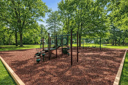 A playground with a swing set and a slide at Emerald Pointe, Riverdale, GA