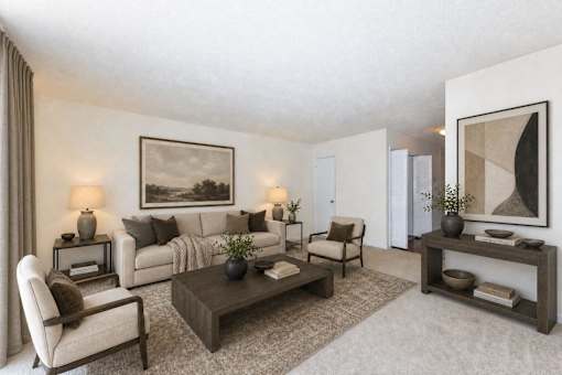 A living room with a couch, chair, and coffee table.