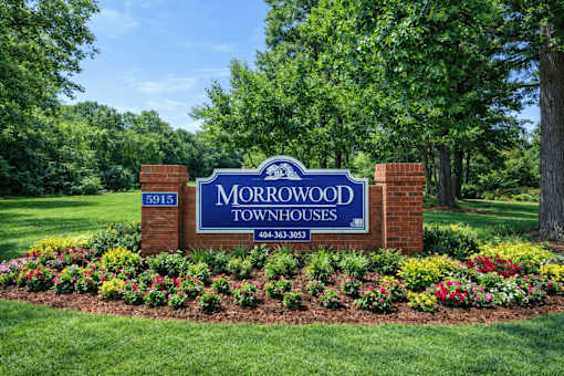 A sign for Morrowood Townhouses with a phone number on it.