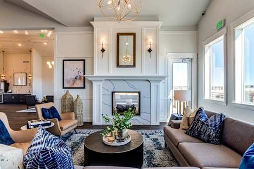 Spacious living room with marble fireplace and vaulted ceiling at Connect at First Creek Apartments, Denver, 80249