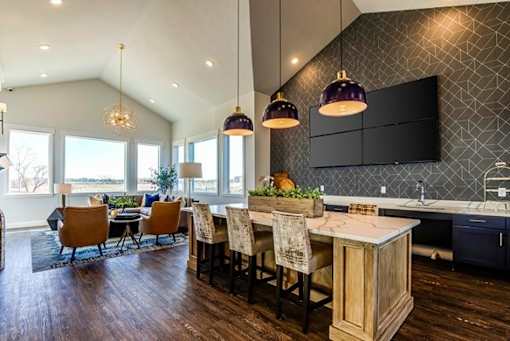 Open kitchen with island and herringbone backsplash at Connect at First Creek Apartments, Denver, Colorado