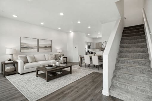 A living room with a staircase leading to the upper floor.