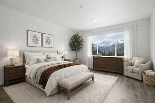 A bedroom with a large bed, a chair, and a mountain view through the window.