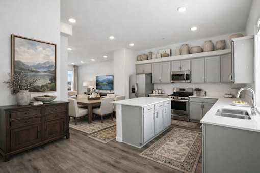 A kitchen with a dining table and chairs in the middle of the room.