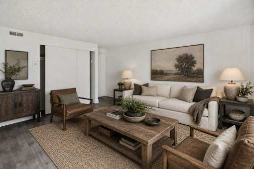 Living room with neutral tones and wood accents at Park Station Apartments, Midvale, UT 84047