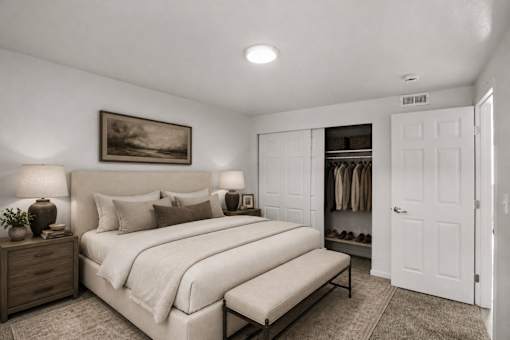 Spacious bedroom with walk-in closet and bench at Park Station Apartments, Midvale