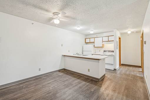 A kitchen with white cabinets and a wooden island.