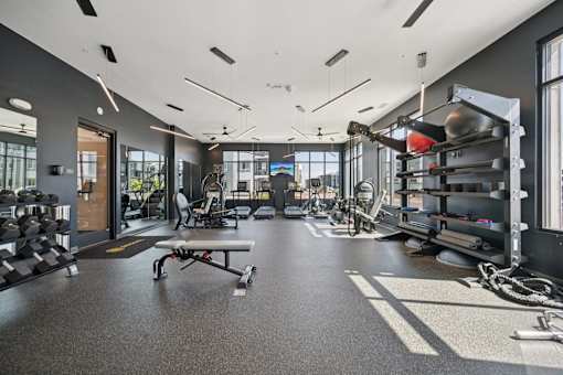 Fitness center with weight equipment and cardio machines at Sequel Homes Apartments, Englewood, CO 80110
