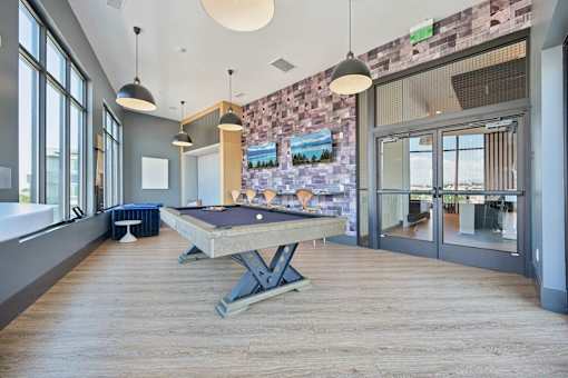 Game room with pool table and pendant lighting at Sequel Homes Apartments, Englewood, CO 80110