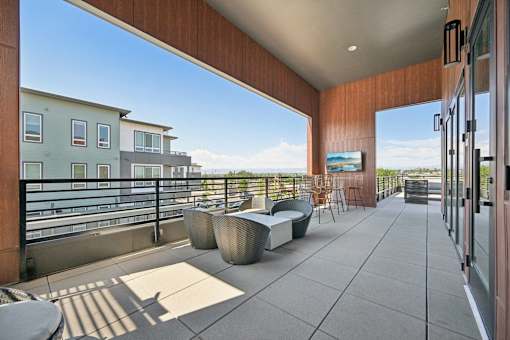 Rooftop terrace with lounge seating and views at Sequel Homes Apartments, Englewood