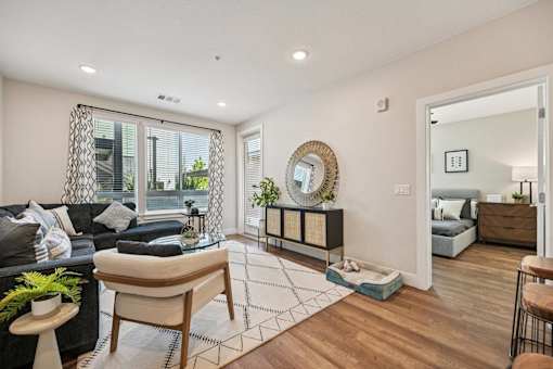 Bright living room with wood flooring and bedroom view at Sequel Homes Apartments, Colorado, 80110