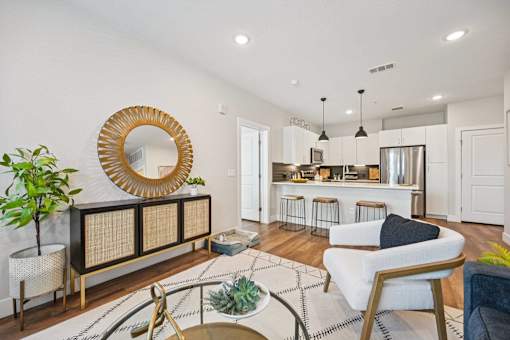 Open concept living area with kitchen island at Sequel Homes Apartments, Englewood, Colorado