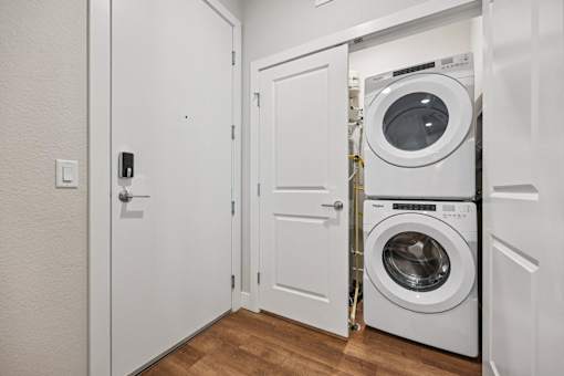 Stacked washer and dryer in laundry closet at Sequel Homes Apartments, Colorado, 80110