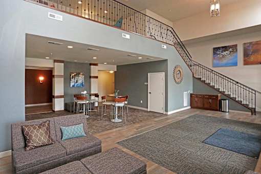 Spacious lobby with curved staircase and seating area at Cypress Court Apartments, St Cloud, Minnesota
