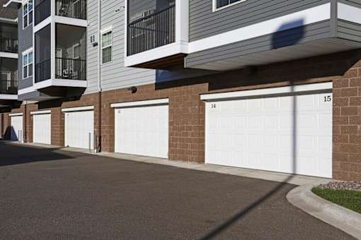 Townhome garages with numbered doors at Cypress Court Apartments, St Cloud