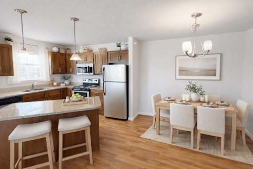 Open kitchen and dining area with wood floors at Cypress Court Apartments, St Cloud, Minnesota