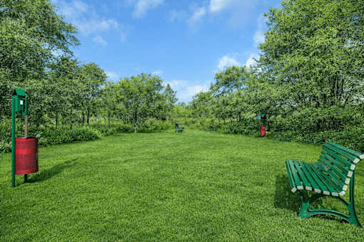 Park area with green bench and landscaping at Grand Gateway Apartments, Minnesota, 56301