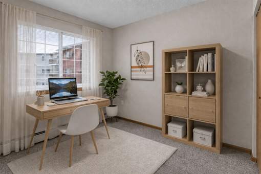 Home office with wood desk and shelving at Grand Gateway Apartments, St Cloud, MN