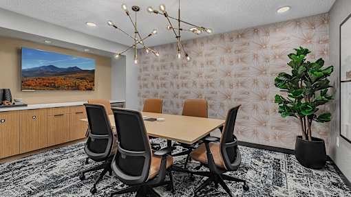 Modern conference room with wooden table at Grand Gateway Apartments, St Cloud, Minnesota