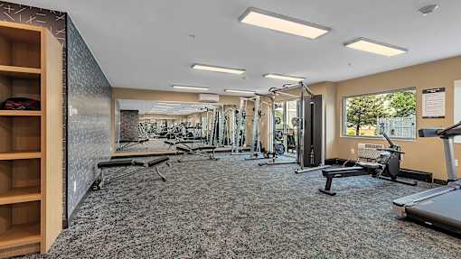 Fitness center with cardio and strength equipment at Grand Gateway Apartments, St Cloud