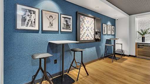 Community cafe seating with gallery wall art at Grand Gateway Apartments, Minnesota, 56301